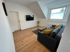 ein Wohnzimmer mit einem Sofa und einem TV in der Unterkunft Appartment Miami , Nähe Düsseldorf ,Messe ,HBF ,City, Netflix , WIFI, HELIOS Hospital in Krefeld