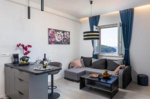 a living room with a couch and a table at Gjenero in Dubrovnik
