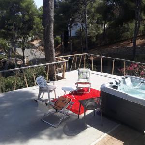 a patio with two chairs and a hot tub at Villa Nicole avec Spa professionnel in Carry-le-Rouet +16 photos