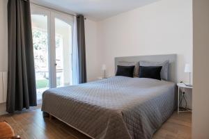 een slaapkamer met een groot bed en een groot raam bij Le Solaret in Sète