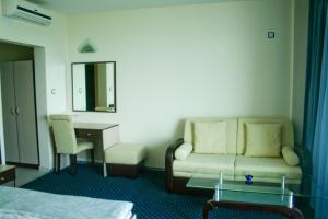 a hotel room with a couch and a desk at Peter Hotel in Ravda