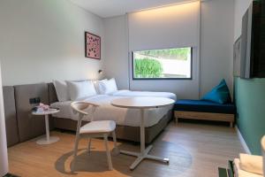 Postel nebo postele na pokoji v ubytování GO! Hotel Chonburi at Central Chonburi