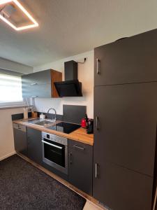 a kitchen with a sink and a stove at Ferienwohnung Laufenburg in Laufenburg