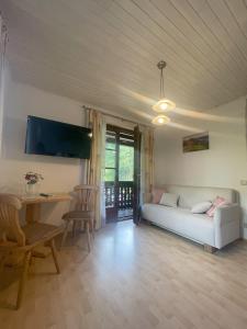 a living room with a couch and a table at Farmreiterhof in Pruggern