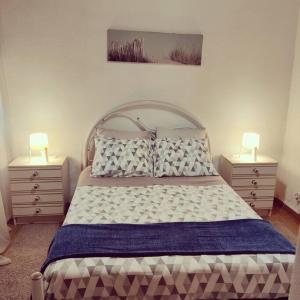 een slaapkamer met een groot bed met 2 nachtkastjes bij A casinha in Cerejeiras