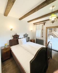 a bedroom with a large bed and a window at Castle View in Saschiz