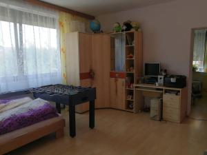 a bedroom with a table and a desk and a computer at Family house 