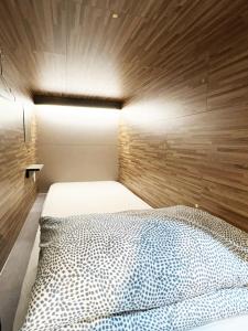 a bedroom with a bed with a wooden wall at Seoul Cube Jongro in Seoul