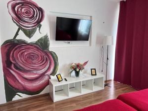 a living room with a painting of roses on the wall at Rose No 4 in Friedrichshafen