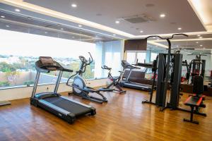 a gym with several exercise bikes in a room at Hotel Blossoms in Tiruchchirāppalli