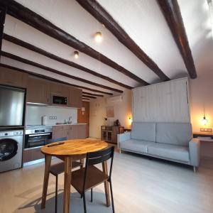 a kitchen with a table and chairs in a room at La Llacuna in Vila-Sana