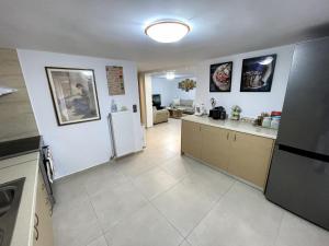 a kitchen with a refrigerator and a counter top at Cozy apartment near sea and airport in Artemida
