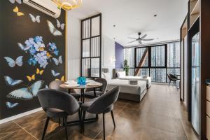 a living room with a table and chairs at Scarletz KLCC Apartments by soulasia in Kuala Lumpur