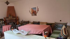 a living room with a table with a pink table cloth at Ourika lodge the healing place in Tafza