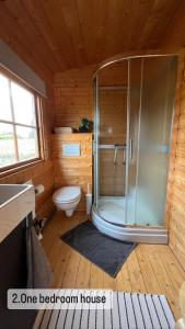 a bathroom with a shower in a wooden house at Armuli in Reynistaður