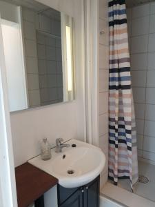 a bathroom with a sink and a shower at St. Strandbygaard in Åkirkeby