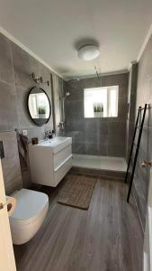 a bathroom with a toilet and a sink and a shower at Heklan in Hafnarfjörður