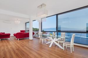 a living room with a glass table and a red couch at Villa Bojana in Tivat