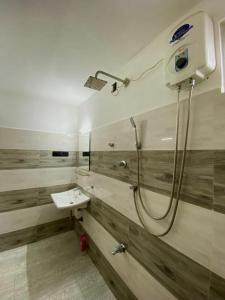 a bathroom with a shower and a sink at Home Stay Polhena in Matara