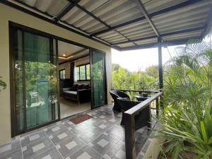a house with a balcony with a living room at Bang Po Hut in Ban Bang Po