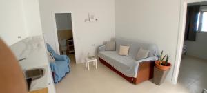una pequeña sala de estar con sofá y silla en Casa tomas C, en Villaverde