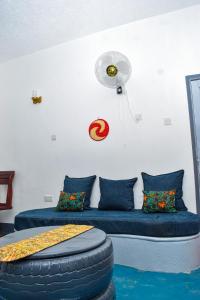 a room with a bed with a large tire on it at Citizen Cafe & Chambers in Mbale
