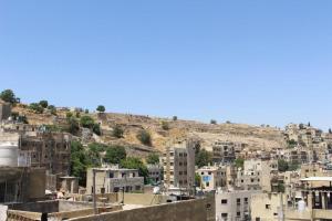 a view of a city with buildings on a hill at Arab Tower Hotel in Amman