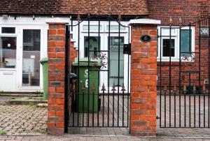 a black wrought iron gate with a green door at Cozy double room - Only room in London
