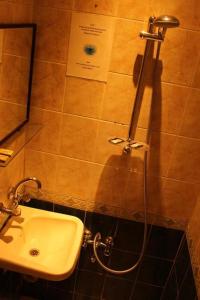 a bathroom with a sink and a shower at Arab Tower Hotel in Amman