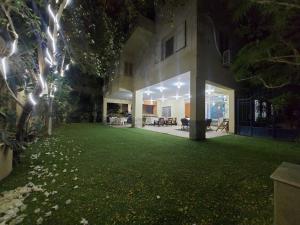 a house with a large yard at night at Duplex villa in 6th Of October