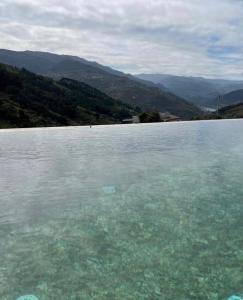 a large body of water with mountains in the background at Outeiro Douro House in Mártir