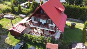 a model of a house with a red roof at Casa dintre Brazi in Arieşeni