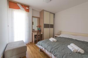 a bedroom with a bed with two towels on it at Villa Novak in Okrug Donji