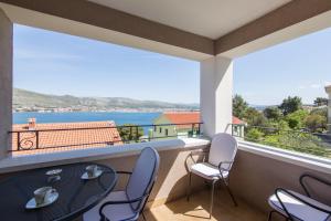 a balcony with a table and chairs and a view at Villa Novak in Okrug Donji