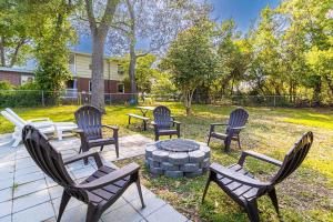 a group of chairs sitting around a fire pit at Beachy Central, Near Beach, 2 King Beds, Crib, Huge Private Yard, Patio, Porch, BBQ, & Firepit in Myrtle Beach