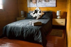 a bed with two pillows on it in a room at Mike's Lodge Sodwana Bay in Sodwana Bay
