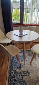 a table and chairs in a room with a window at Hillend Self-Catering in Portree
