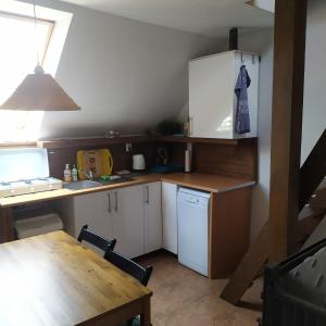 a kitchen with a desk and a table and a table and a table at Nad Dunajcem in Sromowce Niżne +13 photos