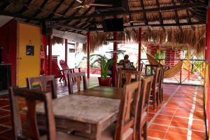 a dining room with a table and chairs and a person at Hostal La Guaca in Cartagena de Indias