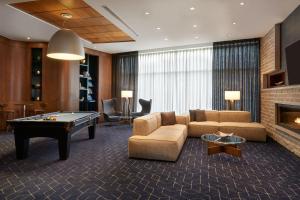 a living room with a couch and a pool table at Residence Inn by Marriott Calgary Airport in Calgary