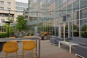 a patio with tables and chairs in front of a building at Residence Inn by Marriott Calgary Airport in Calgary