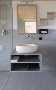 a bathroom with a sink and a mirror at Das Baumhaus in Völs am Schlern