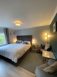 a bedroom with a large bed and a living room at No 12 B&B in Dungarvan