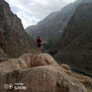 a person standing on a rock looking at a canyon at Jumaboy Guesthouse 