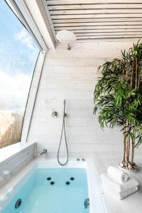 a bath tub in a room with a window at Leobus-לאו באס in Menaẖemya