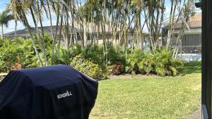 aatal tent in front of a yard with palm trees at Mermaids & Marlins Private House & Pool in Cape Coral