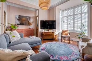 a living room with a couch and a tv at Adelaide House in Ulverston