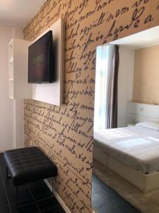 a bedroom with a wall with writing on it at Hotel La Rocca in Nogarole Rocca