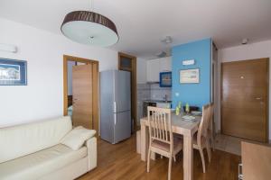 a kitchen and dining room with a table and a couch at Villa Novak in Okrug Donji