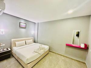 Postel nebo postele na pokoji v ubytování Hotel Dlima Inn Bukit
